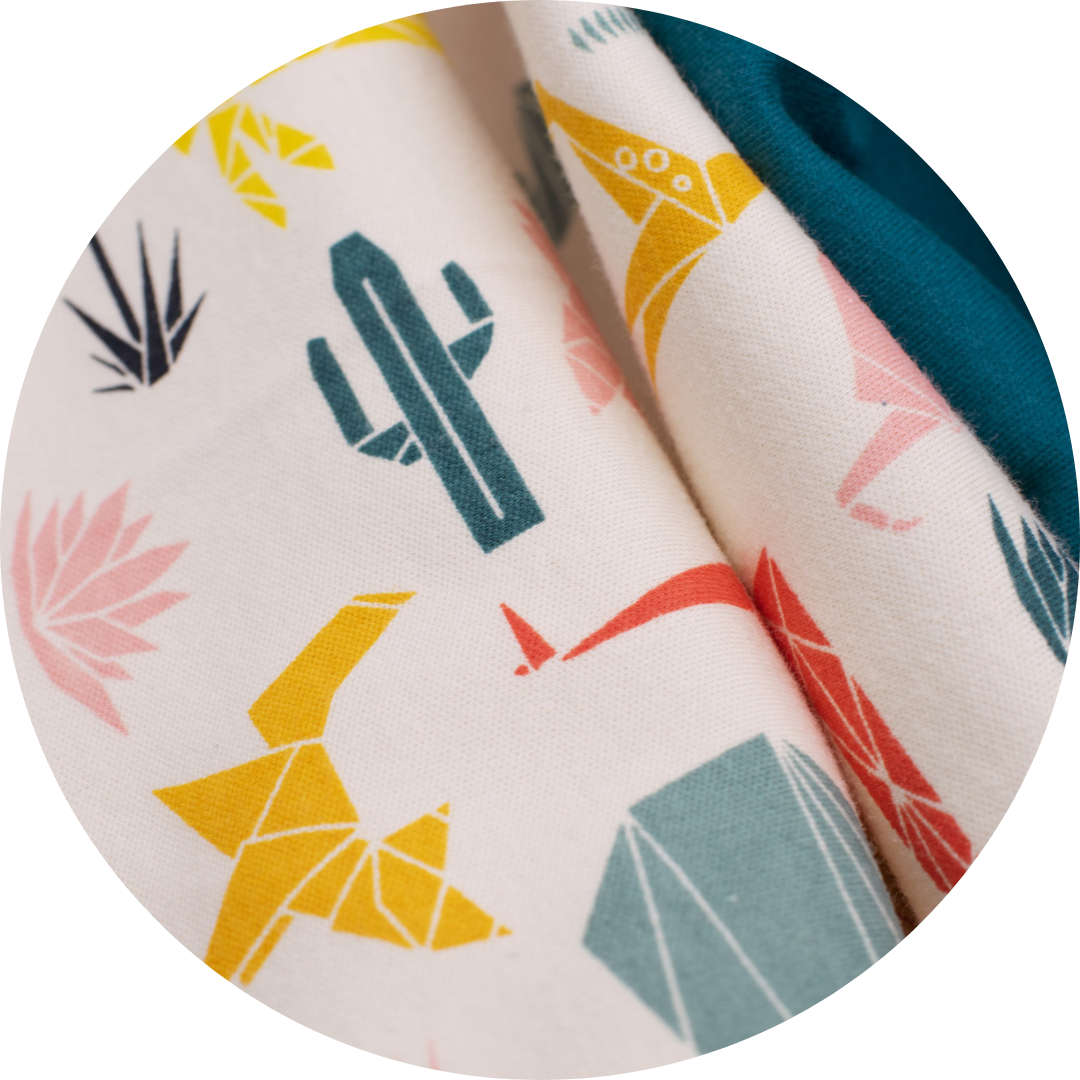 multicolor geometric plants and animals on tan fabric