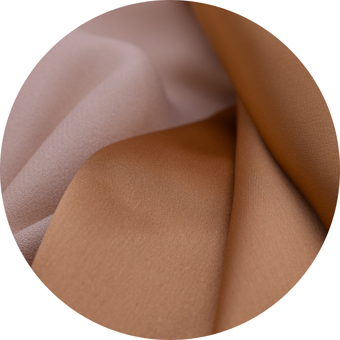 caramel colored silky fabric next to tan crepe fabric