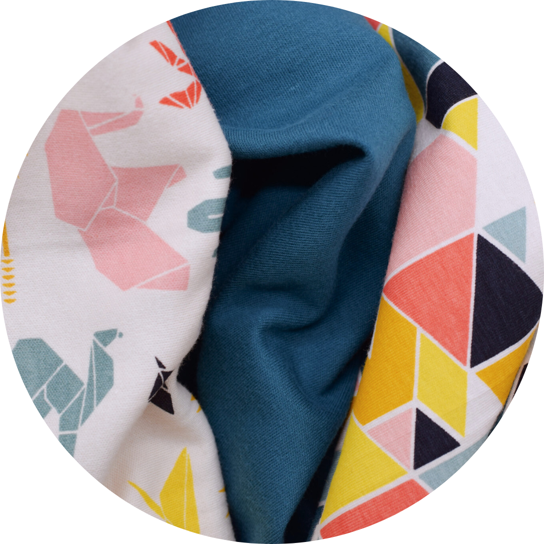 trio of animal print, solid teal, and geometric shape fabrics next to each other