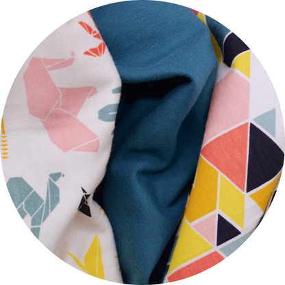 trio of animal print, solid teal, and geometric shape fabrics next to each other