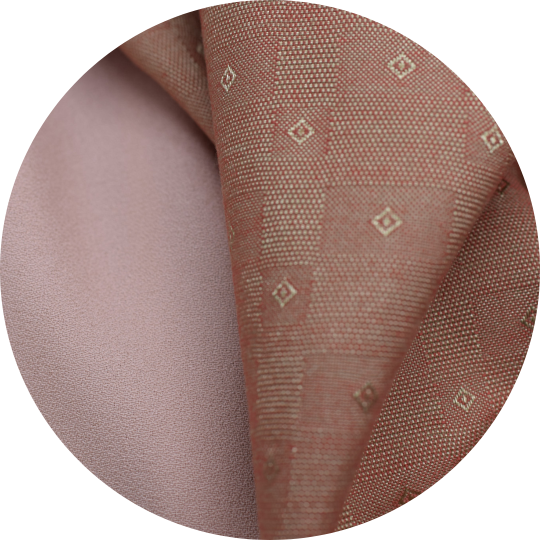 gold and red jacquard fabric next to tan crepe fabric