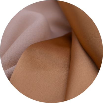 caramel colored silky fabric next to tan crepe fabric